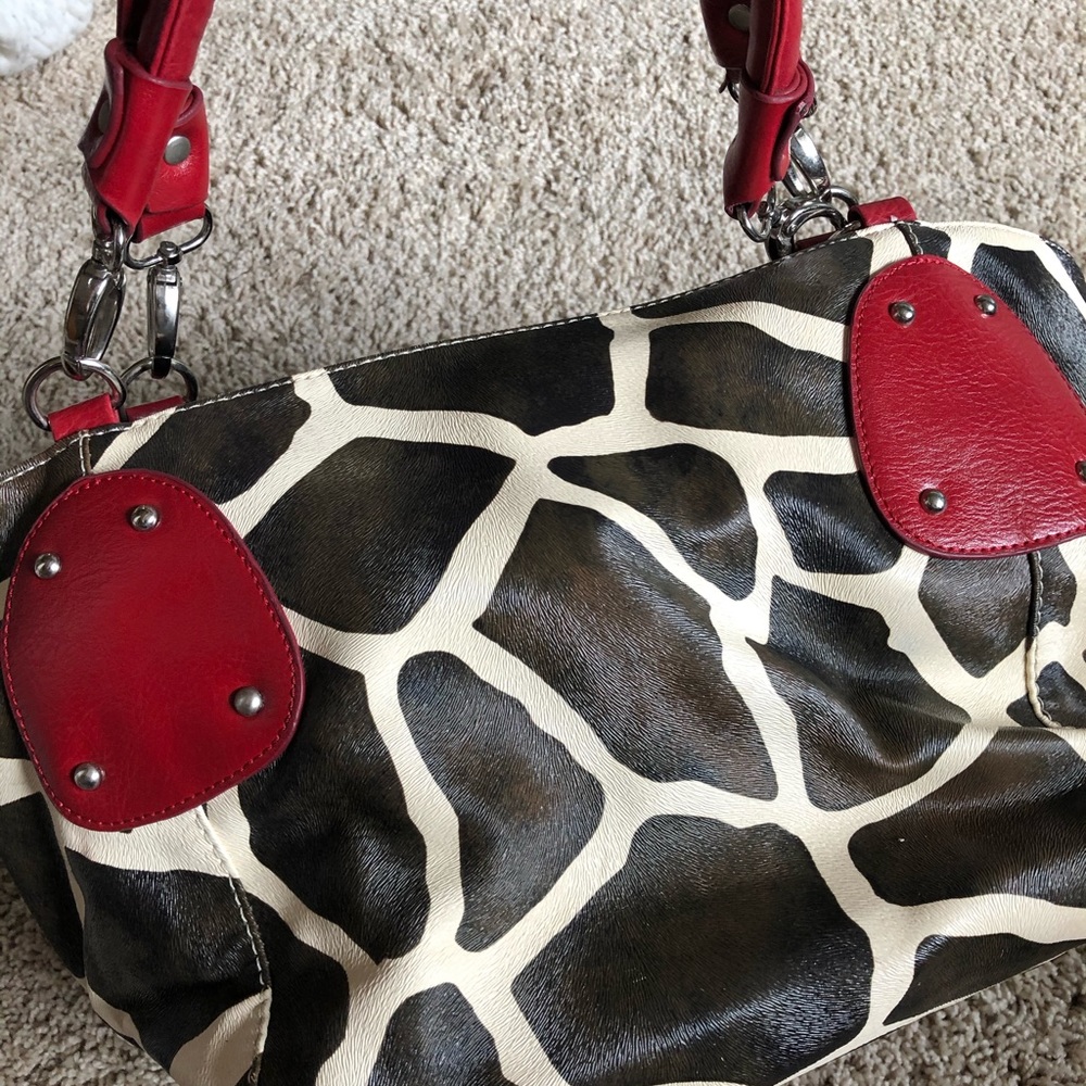 Giraffe print purse with red detail